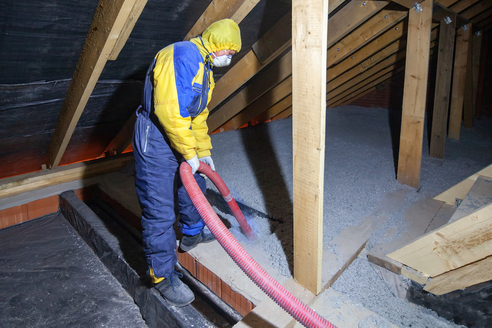 Insulation of the attic floor with cellulose insulation. Spraying from a hose