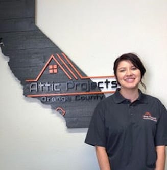 Attic Projects Team Member Vanessa in Front of Attic Projects Sign
